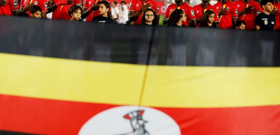Ugandan players standing with national flag before match