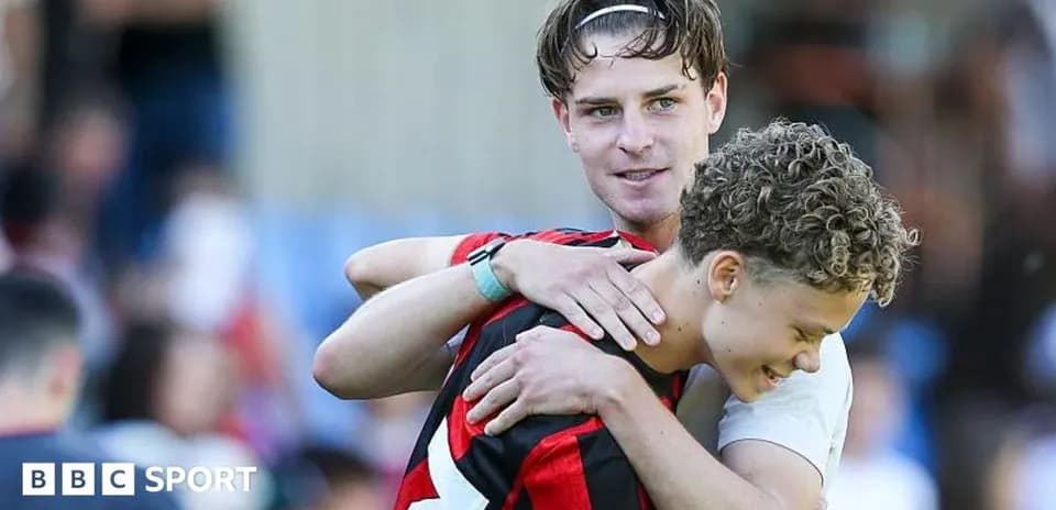 Two players embracing on the field after match