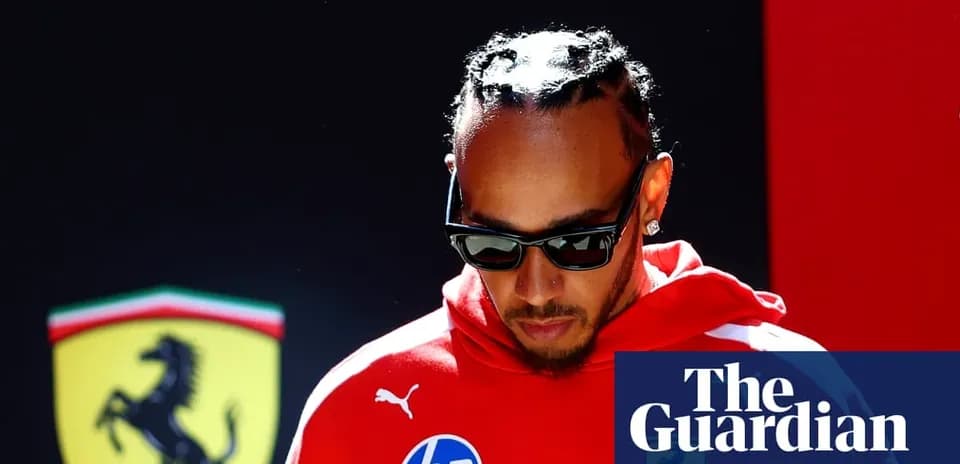Formula 1 driver in red team gear walking