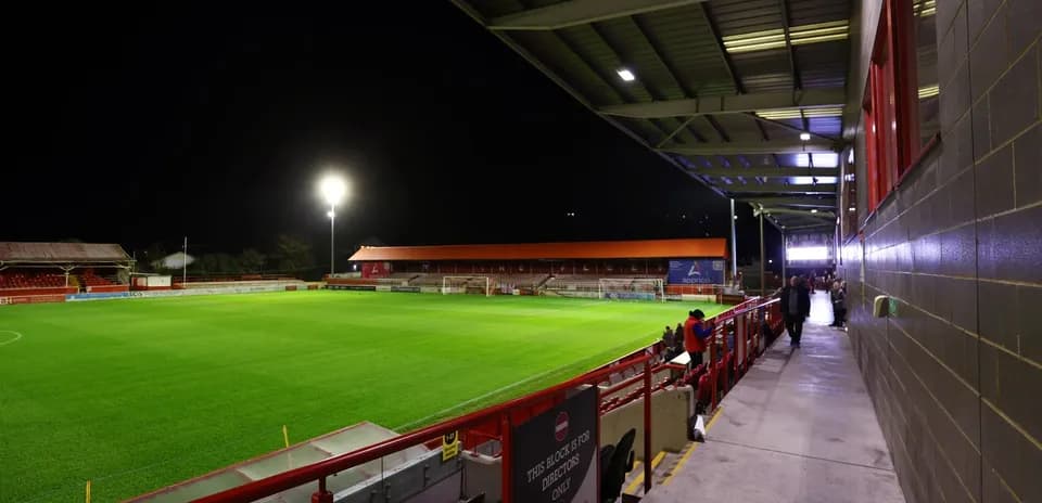 Stadium view with green pitch at night