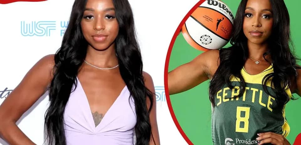Basketball player posing with ball in team jersey