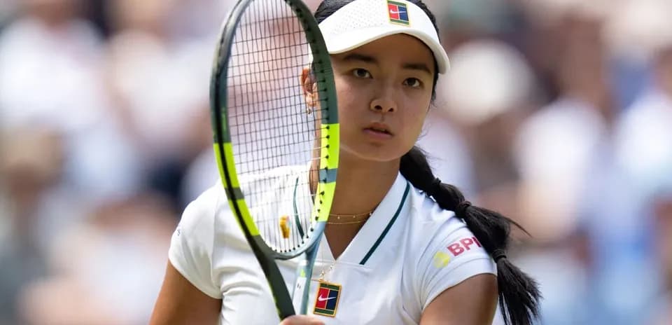 Tennis player preparing to serve on court