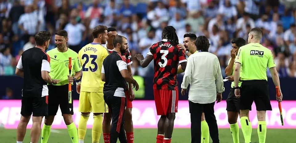 Players and officials discussing on the field