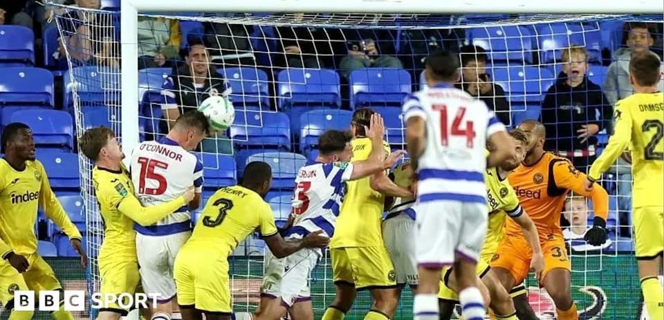 Players contesting a header in front of the goal