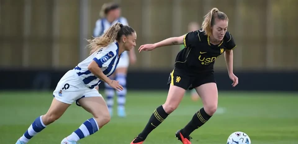 Two female players competing for the ball