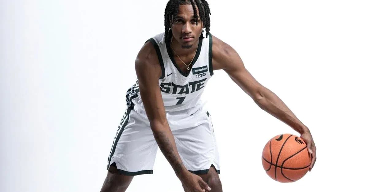 Basketball player posing with ball in uniform