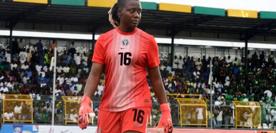 Goalkeeper in red jersey walking off the field