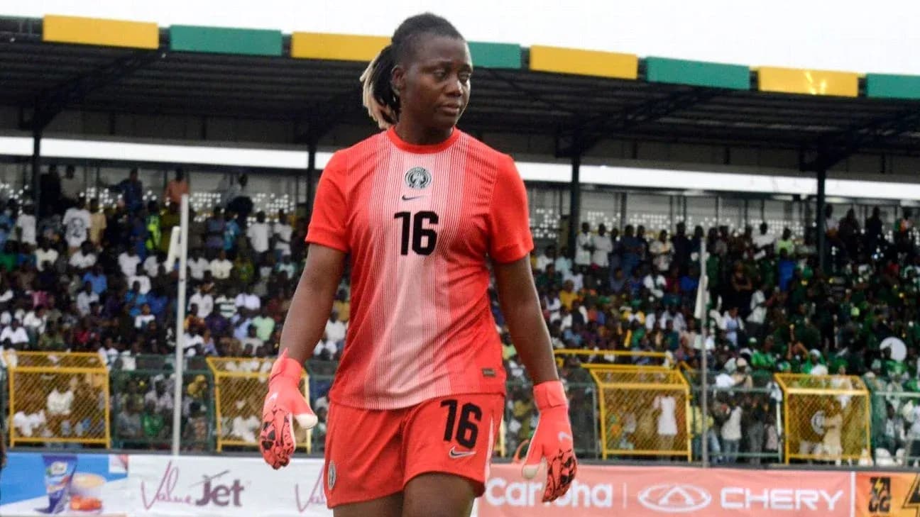 Goalkeeper in red jersey walking off the field