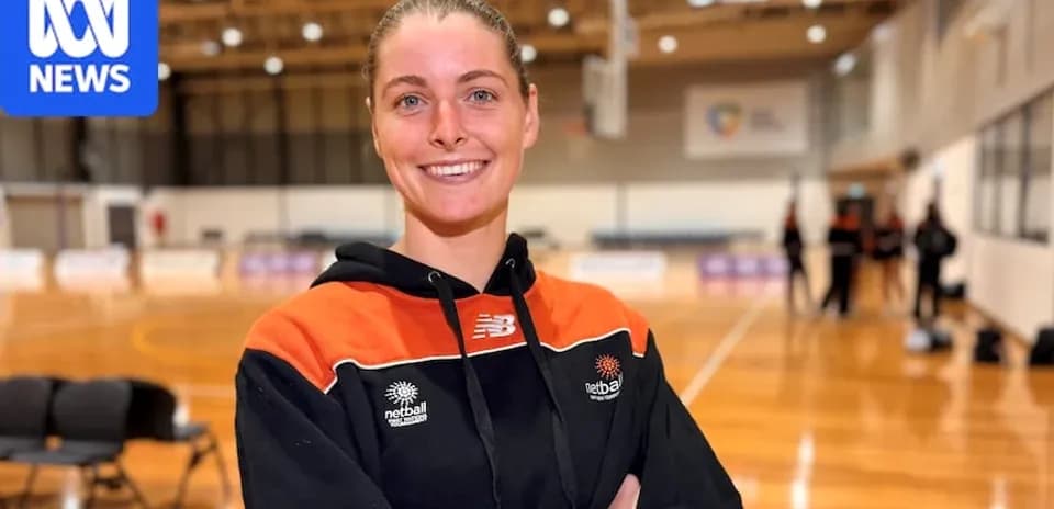 Athlete smiling in netball training venue