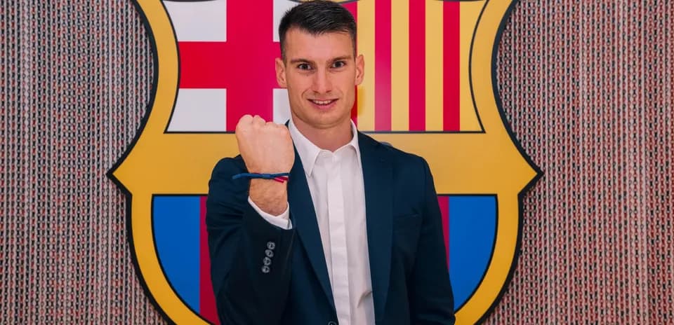 Yoshinori Muto standing in front of FC Barcelona logo