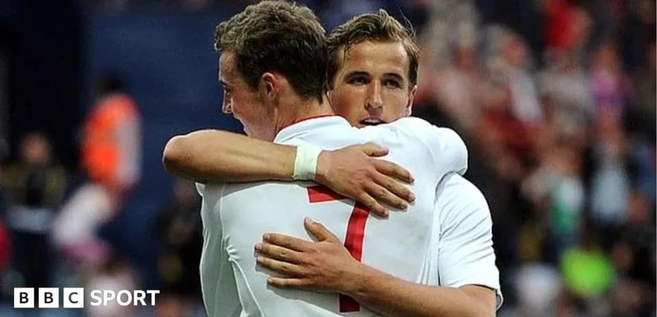 Two players embracing on the football field