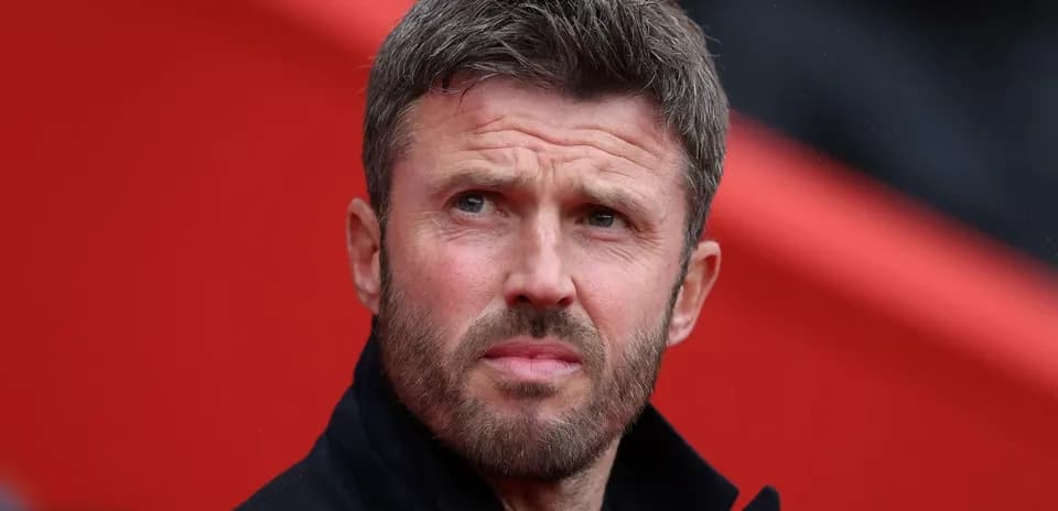 Man with short hair and beard in stadium