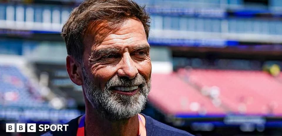 Men's football coach smiling before match