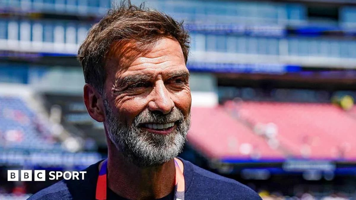 Men's football coach smiling before match