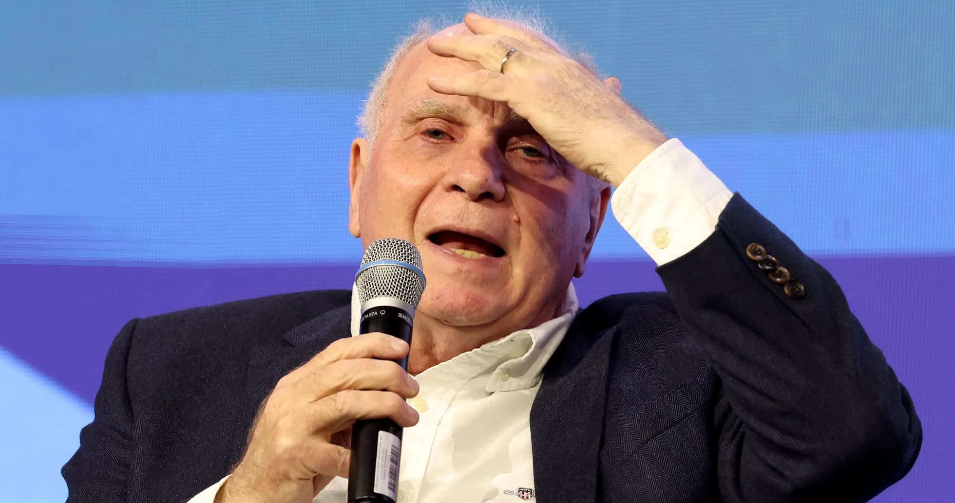 Speaker discussing at event with microphone in hand