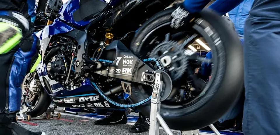 Motorcycle undergoing tire change in the pit