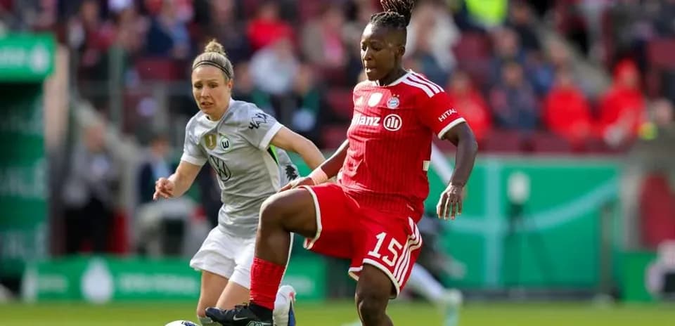 Two players competing for the ball during match