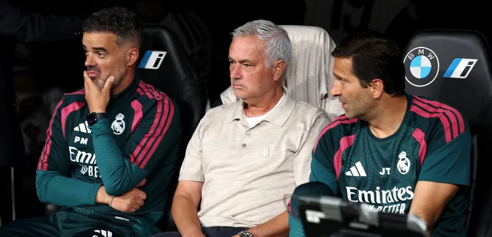 Real Madrid coaching staff seated on the bench