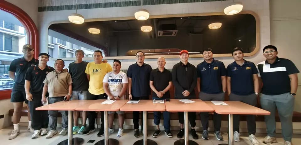 Group of people posing in a restaurant setting