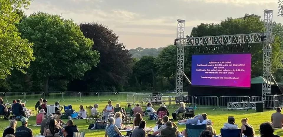 People watching an outdoor movie screening in park