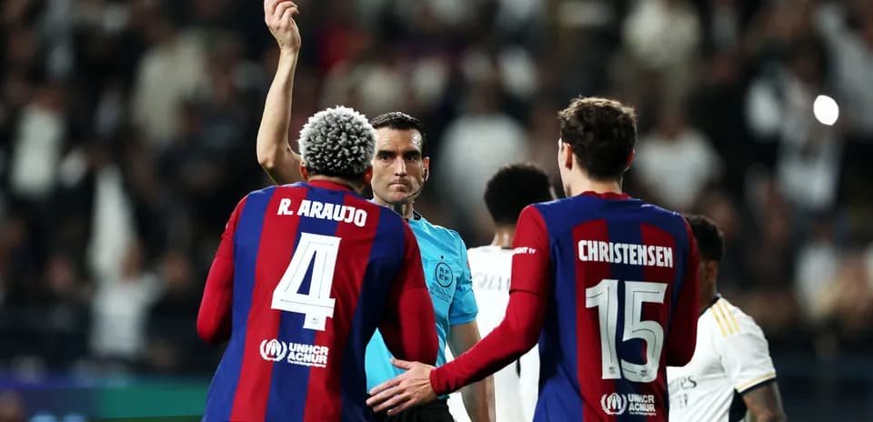 Referee showing yellow card to player during match