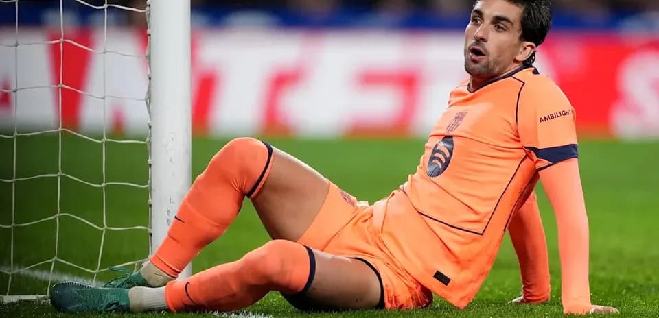Goalkeeper sitting by the goalpost during match