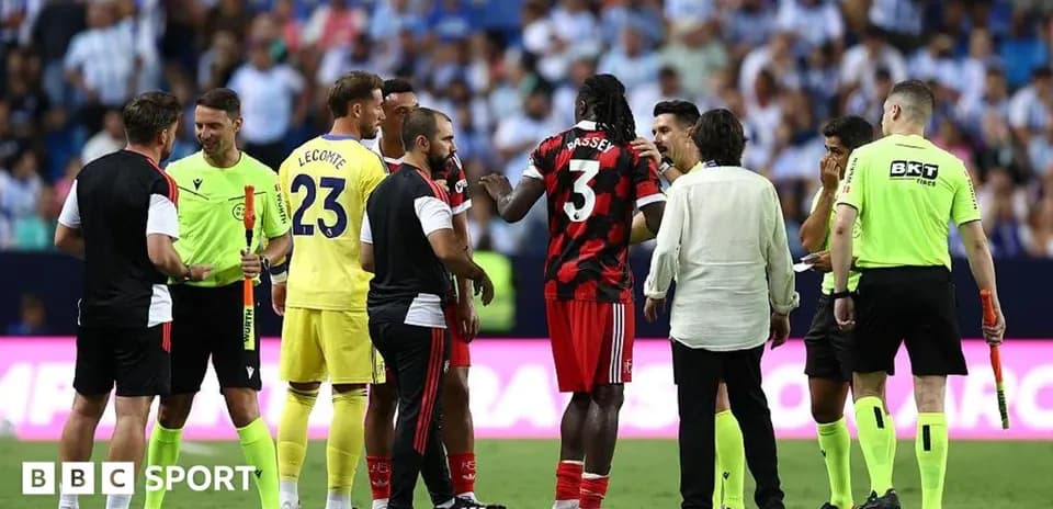 Players and referees discussing during match stoppage