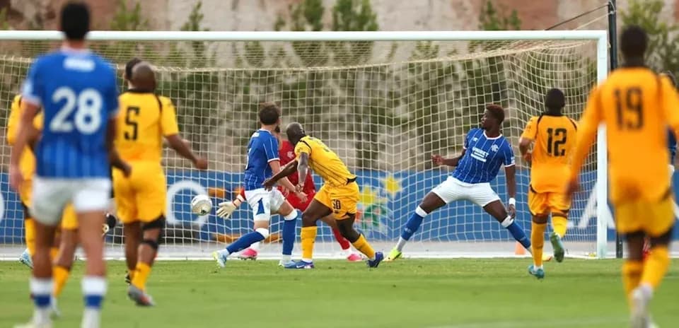 Football players during a match near the goal