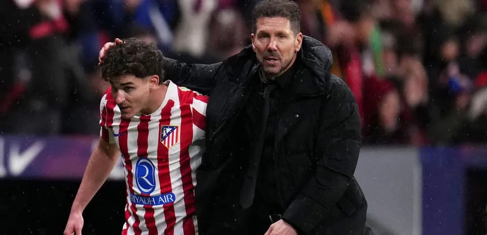 Atletico Madrid player and coach discussing on the field