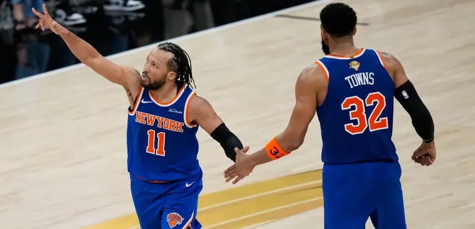 New York Knicks players celebrating on the court