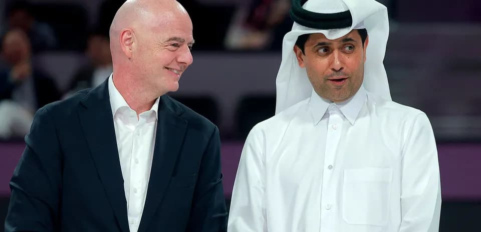 Two officials conversing at event in Qatar
