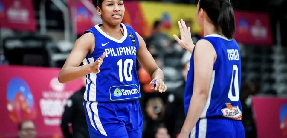 Two basketball players celebrating during the game