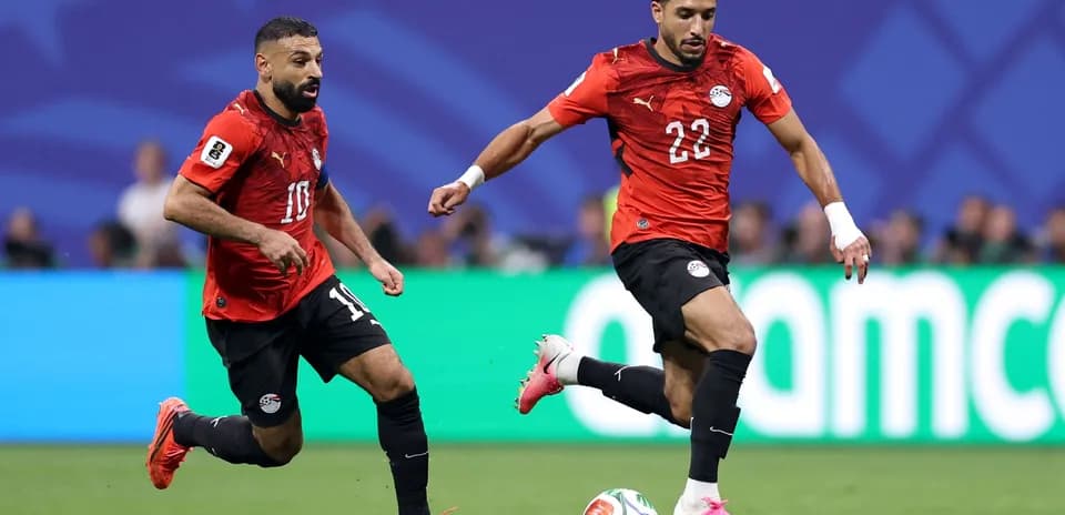 Egyptian players in red jerseys during match action