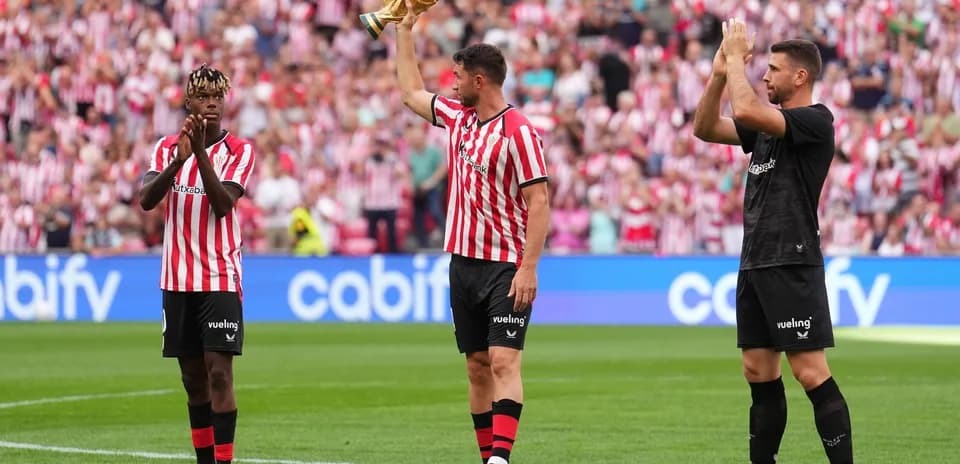 Athletic Club players celebrating with trophy at stadium