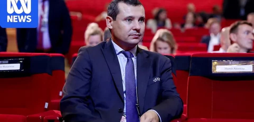 Man sitting in conference hall with empty seats