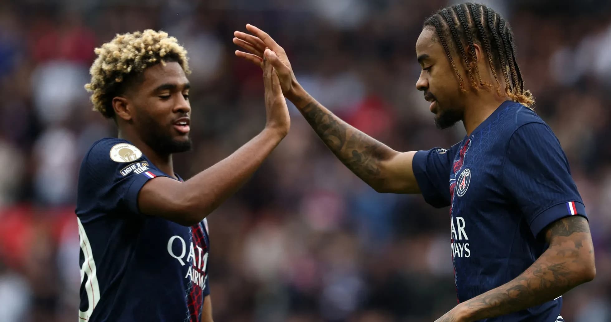 PSG players celebrating with a high-five