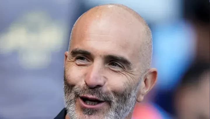 Bald man smiling during sports event