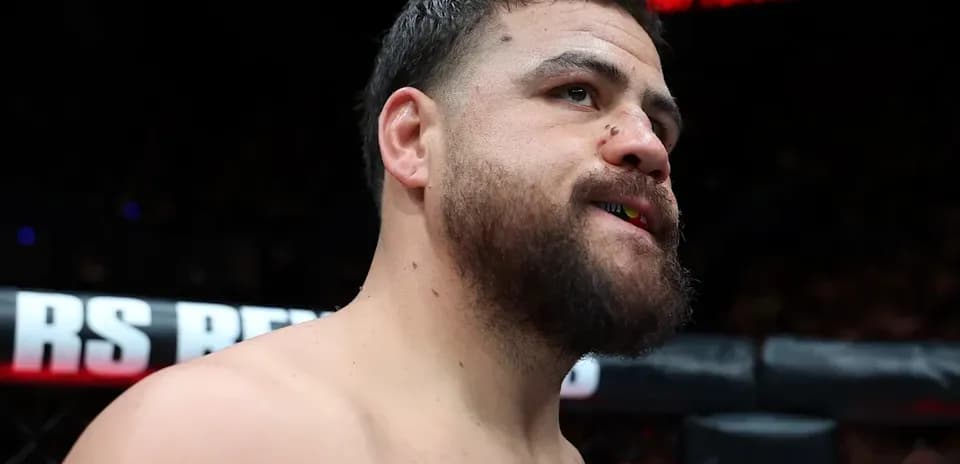 MMA fighter with mouthguard in cage before match