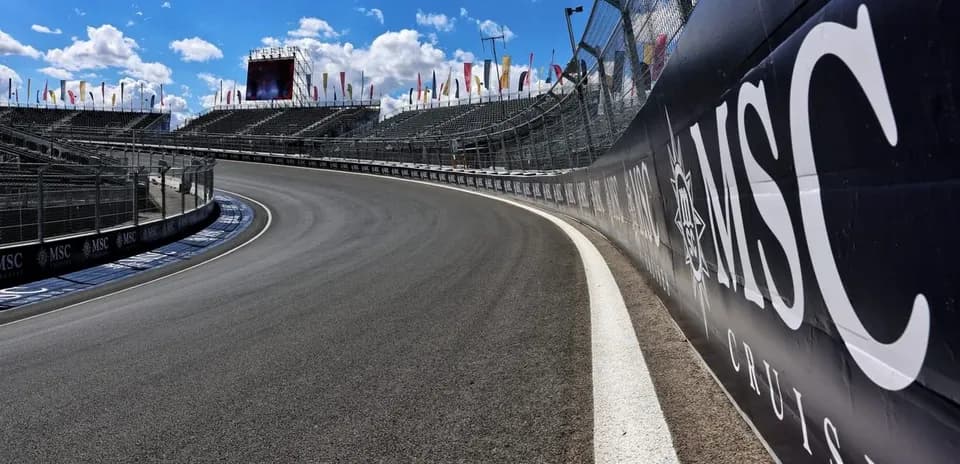 Curved racetrack with grandstands and banners