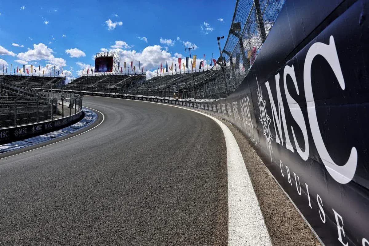 Curved racetrack with grandstands and banners
