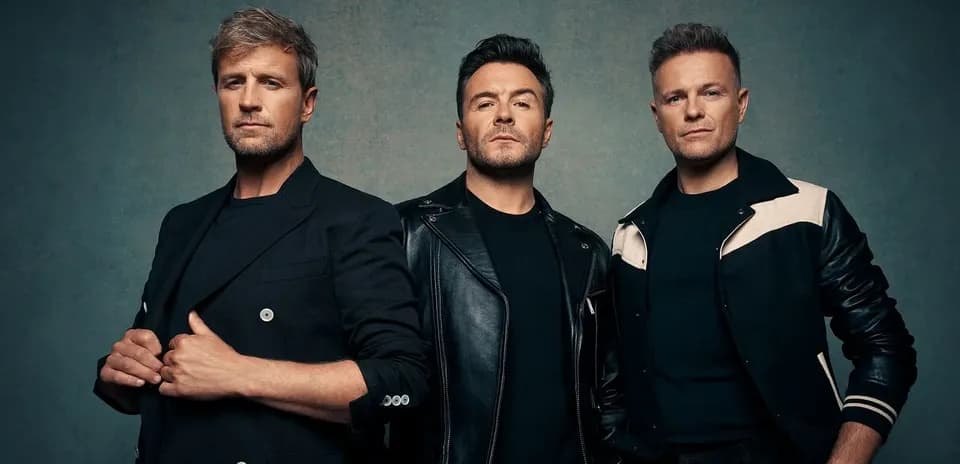 Three men posing against a textured background