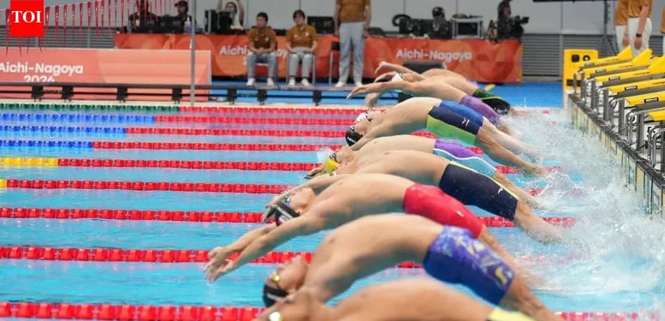 Swimmers diving off blocks in competition