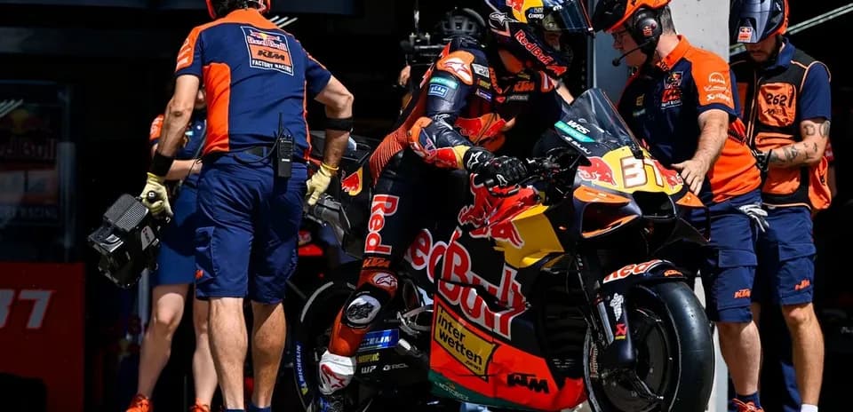 Rider preparing to leave pit box on motorcycle