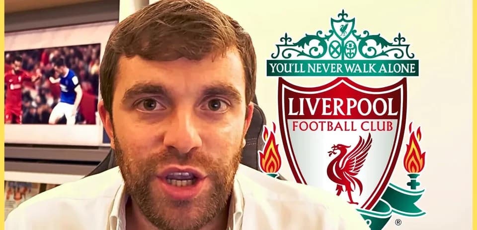 Sport journalist speaking with Liverpool logo behind