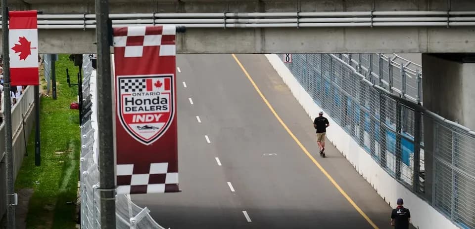 Two people walking on the race track at Indy