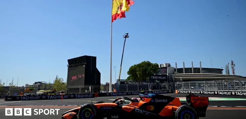 Formula 1 car on track with Spanish flag backdrop