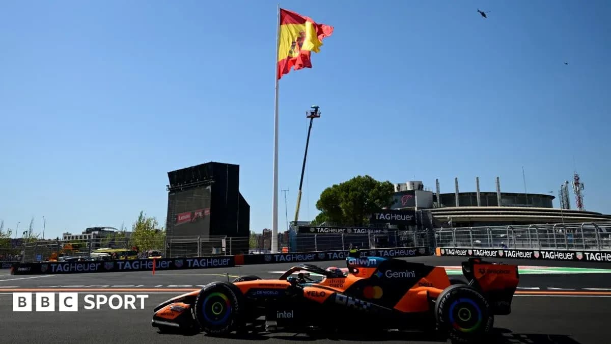 Formula 1 car on track with Spanish flag backdrop