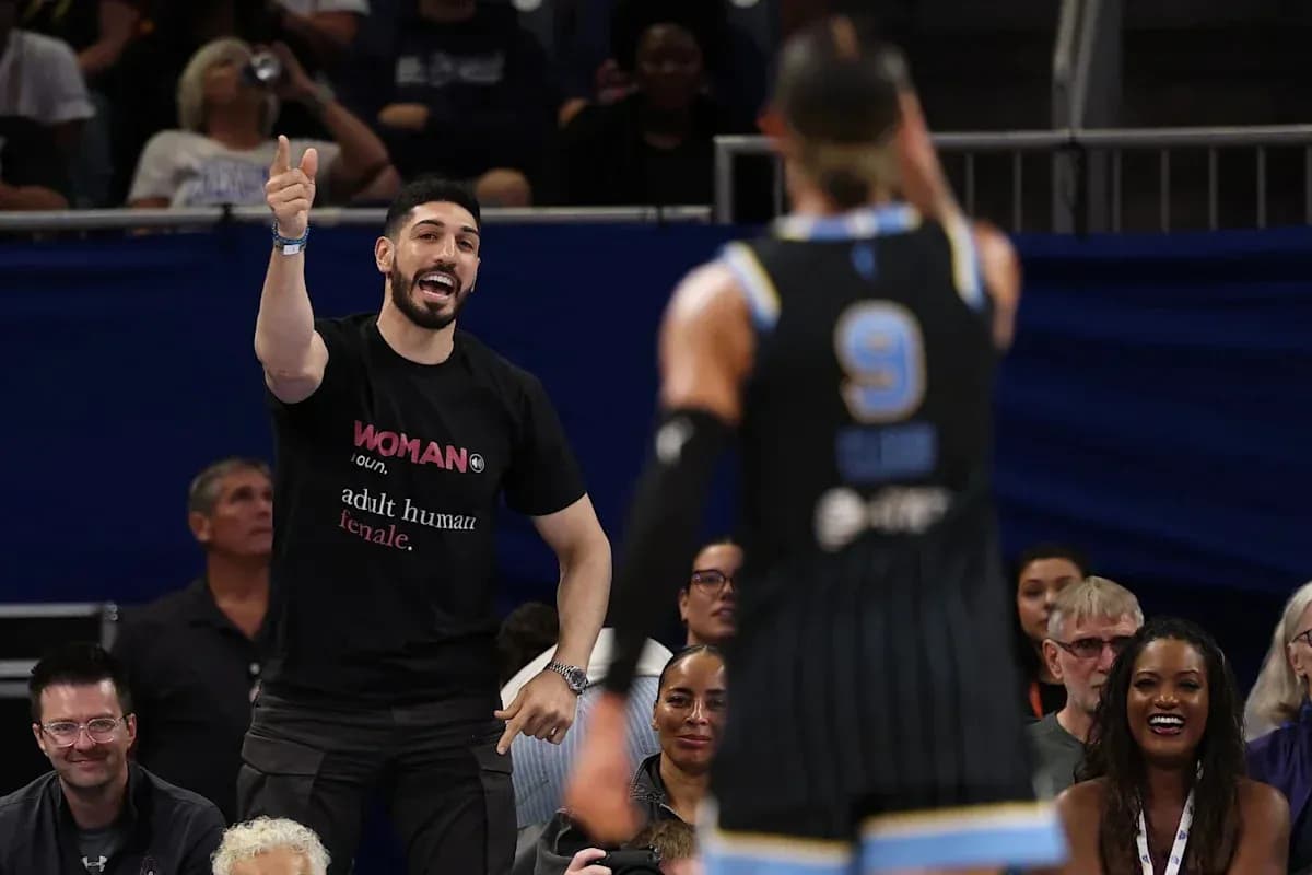 Fan cheering during basketball game with players visible