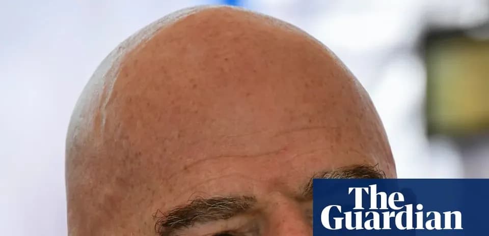 Bald man with eyebrows looking at camera