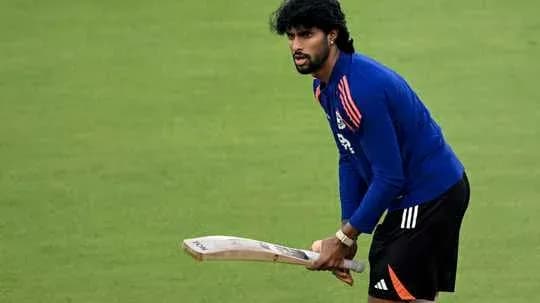 Cricketer practicing with bat on training field